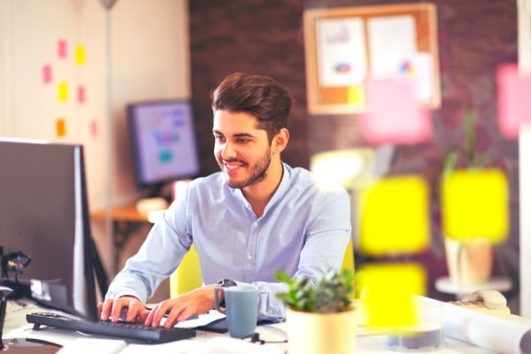 business man happily working on his laptop