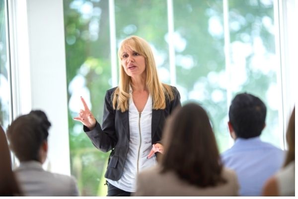 Woman training employees on cybersecurity best practices